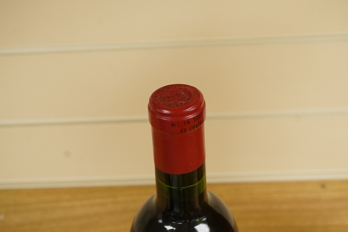 A bottle of Fonseca 1970 vintage port, a bottle of 1970 Chateau Grand-Puy-Lacoste, a litre bottle of Bounty rum and a litre bottle of Harvey’s Bristol Cream